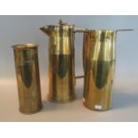 Three brass trench art shell cases, one converted and marked 'hot water' with wooden handle and