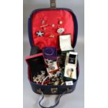 Small suitcase of assorted costume and silver jewellery, bangles, pendants on chains, bracelets,