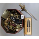 Tin box of oddments to include bottle openers, miniature sword, brass cork screw, vintage keys, clay