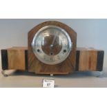 1930's mixed woods three-train mantel clock on shaped metal legs. (B.P. 21% + VAT)