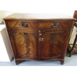 Reproduction mahogany serpentine two door blind panel sideboard with dummy drawer, on bracket