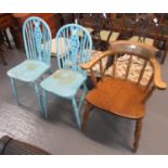 Early 20th century elm smoker bow armchair, together with a pair of painted spindle and wheel back