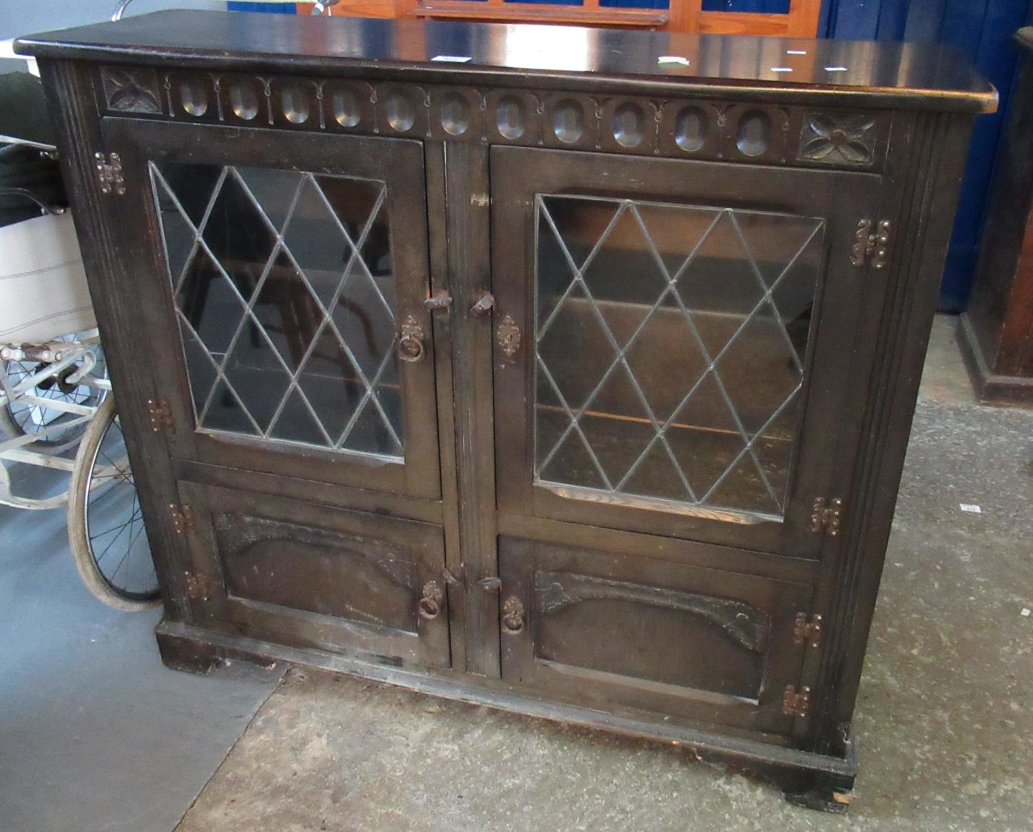 Mid 20th century stained oak lead glazed bookcase cupboard. 110cm wide approx. (B.P. 21% + VAT)