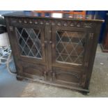 Mid 20th century stained oak lead glazed bookcase cupboard. 110cm wide approx. (B.P. 21% + VAT)