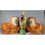 Pair of early 20th century Staffordshire pottery fireside recumbent lions, together with a novelty