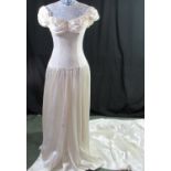 Ivory satin and lace wedding dress. Net neckline above a fitted lace over satin bodice, ruched satin
