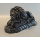 Patinated bronze study of a recumbent male lions, on serpentine shaped marble base. 36cm long