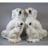 Pair of early 20th century Staffordshire pottery fireside seated Spaniels with painted features,