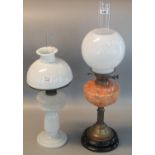 Two early 20th century oil burners, both with opaline glass shade, one with orange marble reservoir.