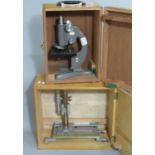 Becks gray enamelled monocular microscope in fitted wooden case, together with a laboratory