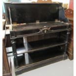 19th century ebonised three-tier buffet, standing on fluted pilasters and a projecting base. (B.P.