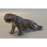 Cold painted spelter study of a roaring tiger, possibly Japanese. 25cm long approx. (B.P. 21% + VAT)