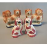 Pair of early 20th century Staffordshire pottery Pekingese fireside dogs on naturalistic oval