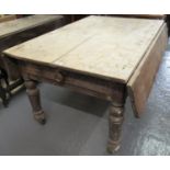 Victorian pine farmhouse table with drop ends on baluster turned legs and castors. 127 x 120 x