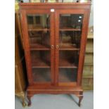 Oak two-door glazed bevelled display cabinet on projecting base and cabriole legs. (B.P. 21% + VAT)