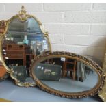 Two 19th century style gilt framed bevel plated oval shaped mirrors with scroll and foliate