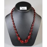 String of 1930's graduated red resin beads (B.P. 21% + VAT)