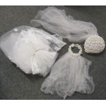 Three wedding veils, one very long white net and lace wedding veil with comb, adorned with white