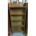 Early 20th century arts and crafts oak five-tier bookcase of narrow proportions with organic
