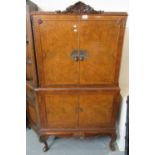 Mid century walnut blind panel two-door cocktail cabinet with carved frieze and cabriole legs. (B.P.