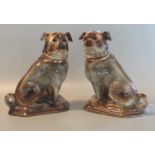 Pair of early 20th century Staffordshire pottery fireside seated pug dogs with glass eyes and