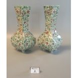 Pair of Royal Doulton D3550 Persian vases overall with parrots, flowers, and foliage. 31cm tall