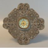 Edwardian lozenge-shaped boudoir clock having enamelled Roman face within a foliate relief mounted