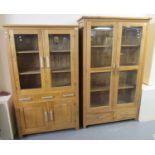 Two similar modern oak two-door glazed display cabinets with an arrangement of drawers. (2) (B.P.
