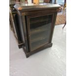 Victorian ebonised and inlaid pier cabinet, the moulded and shaped top above a single glazed door,