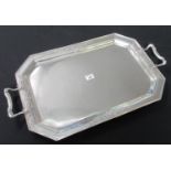 George V silver two-handled tray of octagonal form, with foliate decoration to the edges and