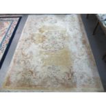 Large beige ground Chinese design wash rug, overall with flowers and foliage with central rose