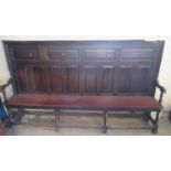 18th century oak high-back settle of large proportions, the moulded top rail above an arrangement of