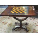 19th century rosewood folding games table, standing on a shaped and baluster turned pedestal and