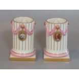 Pair of 19th century Royal Worcester porcelain cylinder vases with fluted columns, pink swags, and