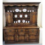 18th century Carmarthenshire style two-stage oak dresser, the moulded cornice above a shaped