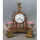 19th century French ormulu two train clock garniture, the arch case surmounted by a bust of