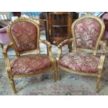 Pair of French design gilded gesso open arm chairs, the arched and padded upholstered backs with