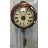 Late 19th century stained beech postman's alarm wall clock with painted Roman face. 22cm diameter