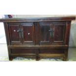 Pair of Chinese hardwood glass top cupboards or cabinets, the moulded top above four fielded panel