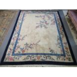 Chinese cream ground floral decorated wash rug with banded boarder and central foliate decoration.