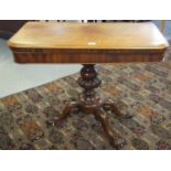 19th century mahogany folding card table, standing on a fluted moulded shaped pedestal and