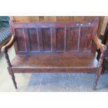 19th century stained pine settle, the moulded rail above six rectangular fielded panels, open shaped