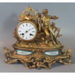 19th century French yellow metal figure mounted two train mantel clock decorated with figure of a