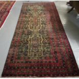 Old vintage Afghan Beluchi Nomadic carpet with unique stylised floral, foliate and geometric design.