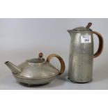 Early 20th century beaten pewter Tudric made for Liberty teapot and coffee pot with woven cane