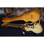 Vintage Gibson 501700 six string electric guitar with four pickups in natural wood finish and