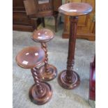 Pair of reproduction stained oak barley twist torchere stands and another with fluted column. (3) (