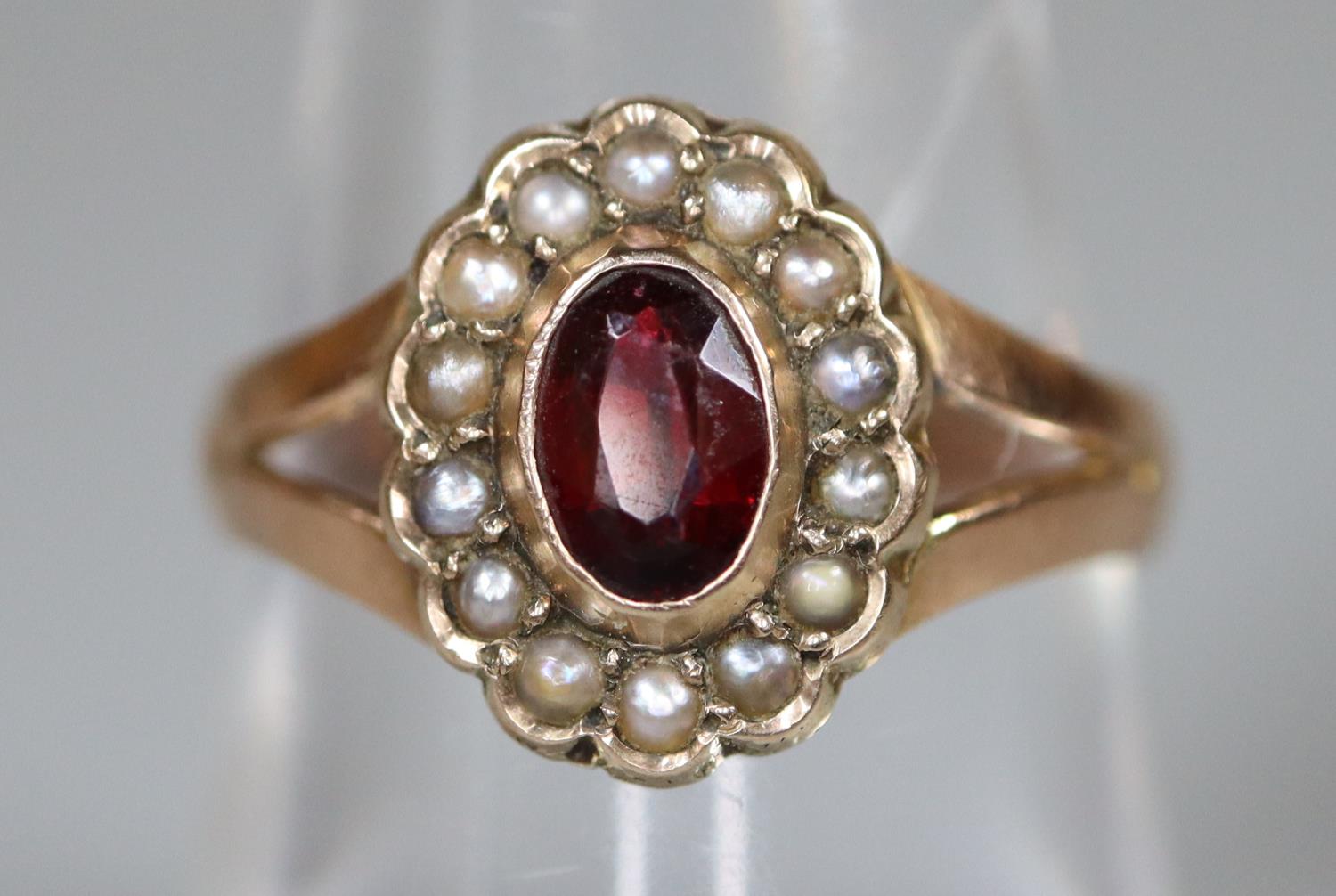 A 9ct gold garnet and pearl ring. Ring size O. Approx weight 1.8 grams. (B.P. 21% + VAT)