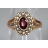 A 9ct gold garnet and pearl ring. Ring size O. Approx weight 1.8 grams. (B.P. 21% + VAT)