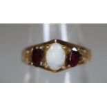 9ct gold opal and garnet ring. Ring size N. Approx weight 3.2 grams. (B.P. 21% + VAT)